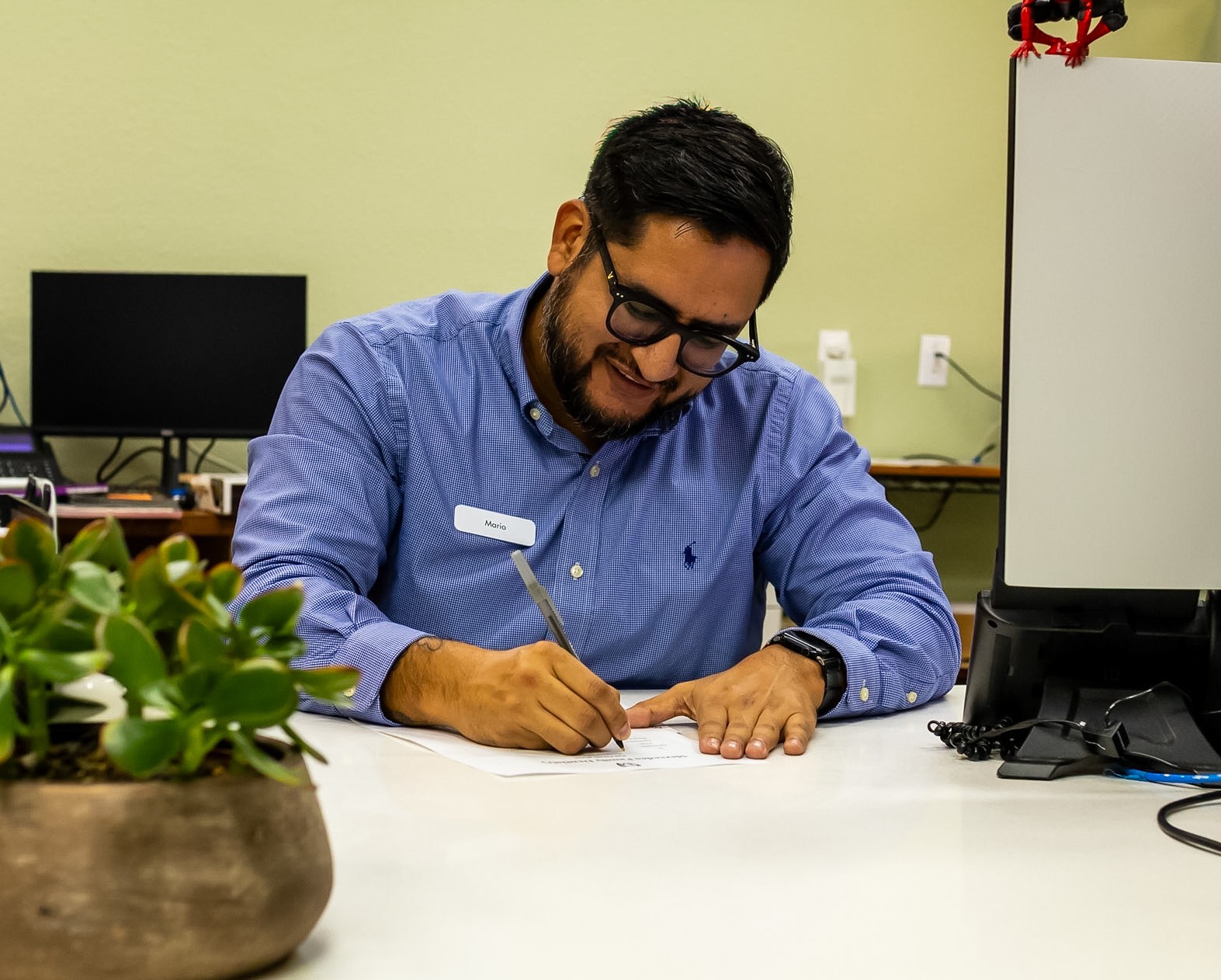 Mario coordinating patient care at the front desk