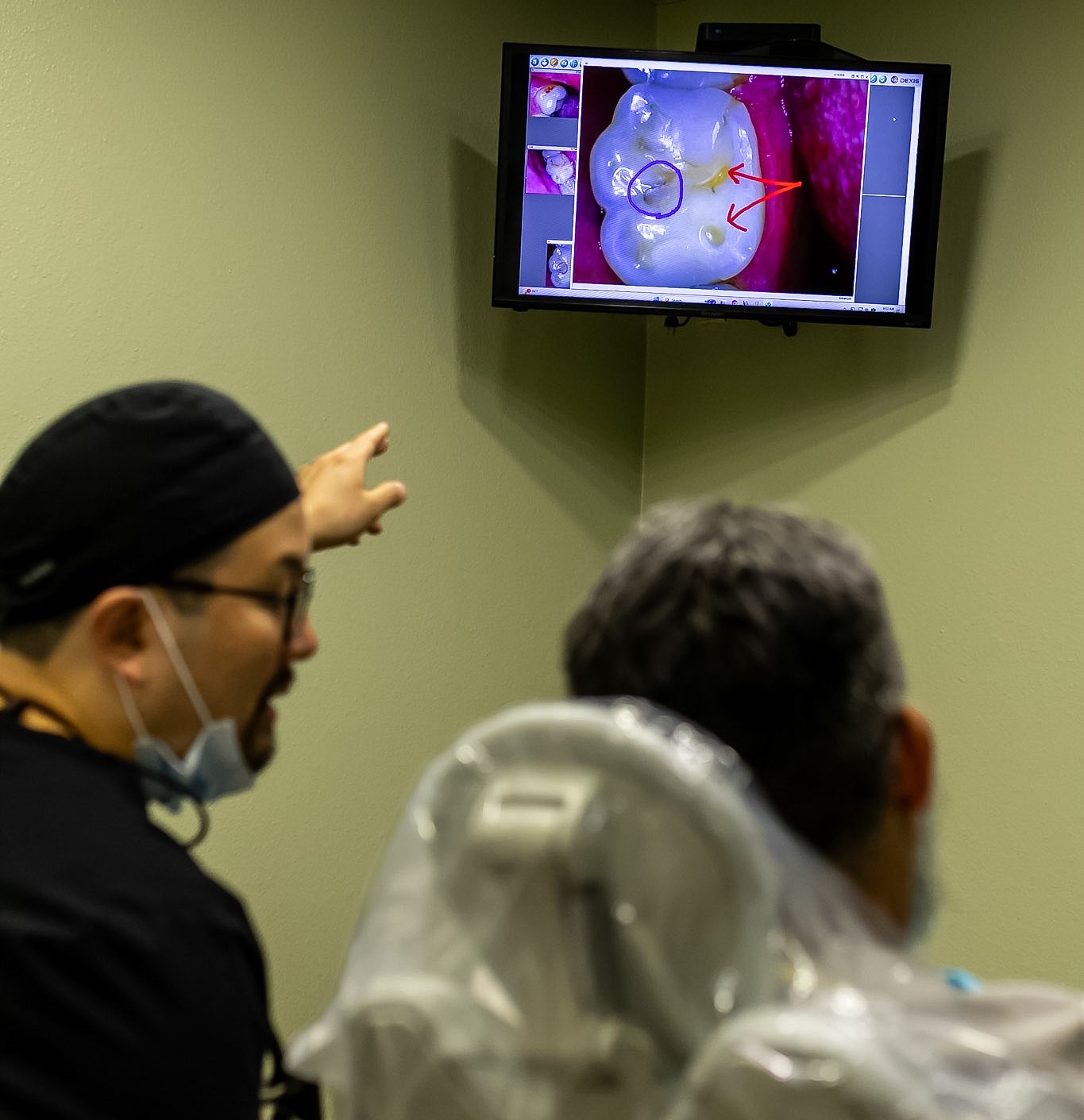 Dr. Kim reviewing a tooth image with a patient